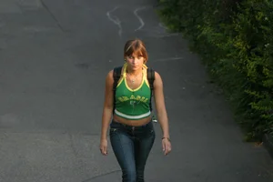 Pretty girl playing tennis in a skirt and walking in jeans