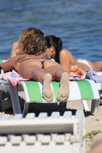 A couple sexy girls laying out on the beach