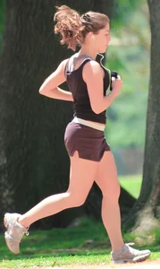 Cute girl running in short shorts