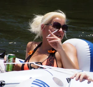 Sexy party girls in bikinis on a lake
