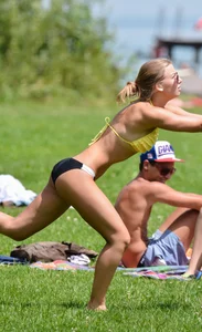 Sexy blonde girl in the park playing volleyball in her skimpy bikini
