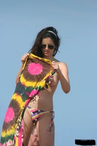 2 topless girls at the beach in thongs
