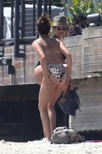 Ashley Tisdale in cheetah print swimsuit on the beach in Malibu