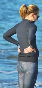 Beach redhead milf in patterened leggings at the beach