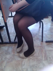 Candid Girl's Legs in Flats And Black Pantyhose Closeup