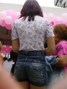 Redhead girl with her cheeks eating her denim shorts