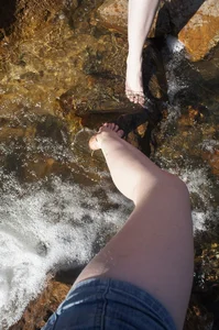 Leg in Shorts with Feet Submerged into River Selfie