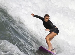 Candid surfer in falling off her board