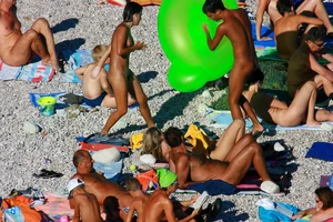 FKK Nudists playing in the water with floater