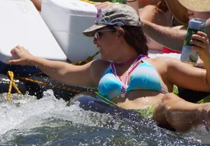Sexy party girls in bikinis on a lake
