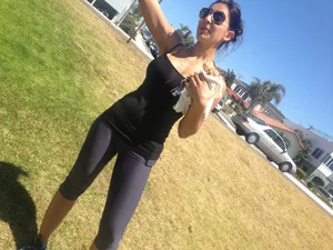 Hot brunette babe in leggings walking her dog with a nice ass and some cleavage