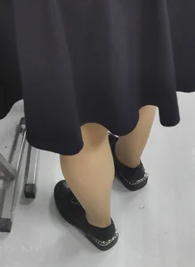 Closeup of a College Teen's Legs in Pantyhose in Class
