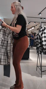 Blonde dutch shop assistent in orange cord leggings