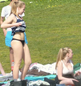 Teen taking off her dress in the park