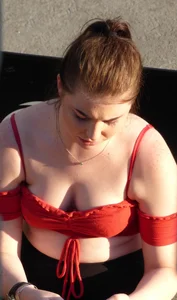 Redhead in little red top showing off her cleavage