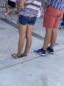 Bunch of girls in various outfits at a Cardinals baseball game