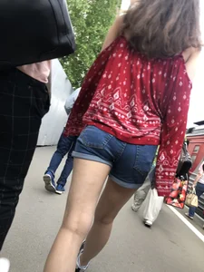 Very hot candid girl in denim shorts walking down the train platform