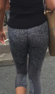 Sexy girl walking in grey patterned leggings with friend in tight jeans