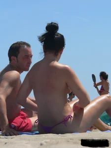 Purple thong topless lady on the beach gets oiled up by her husband