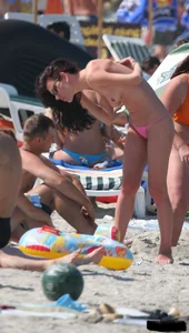 A bunch of sexy beach voyeur babes in bikinis, thongs and topless
