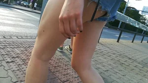 Girl walking in denim shorts showing some of her ass cheeks
