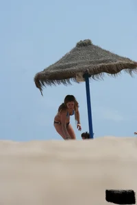 Hot beach girl undressing and going topless