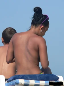 Hot ass topless beach girl with great tits lets her little brother oil up her ass in thong bikini
