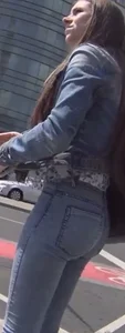 Another girl in tight jeans waiting for the bus