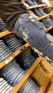 Teen in tight jeans looks to buy another pair