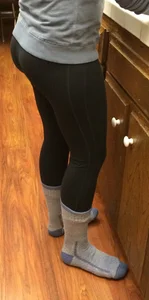 Sexy booty of a girl in leggings and socks at the kitchen