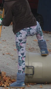 Skinny teen neighbor raking leaves in tight floral patterned leggings