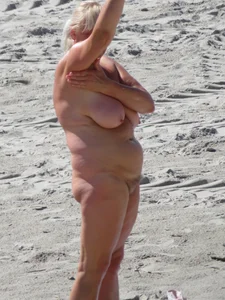 Mature blonde lady on a nude beach with big boobs