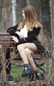 Girl Sitting on a Park Bench in Skirt and Pantyhose