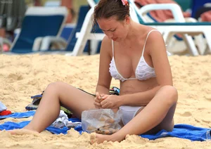 Sexy beach babe in see through wet white thong bikini