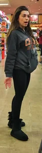 Fit shopping brunette girl in leggings and a hoodie with a nice ass
