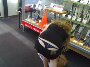 Girl in Denim Shorts Bending Over at the Store with Her Strings Peeking Out Whaletail Candid Photo