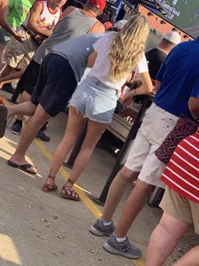Bunch of girls in various outfits at a Cardinals baseball game