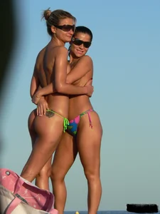 Bunch of sexy babes on the beach topless and in thong bikinis