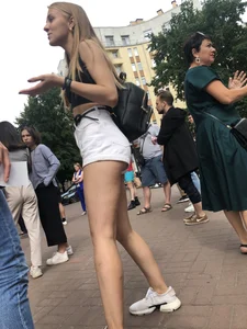Hot Candid Girl in a Top, Shorts and Sneakers Skinny Legs Closeup Creepshots Gallery on the City Street