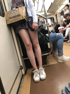 Blonde with Cute Skinny Legs in a Dress Standing in a Subway Train Creepshot