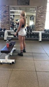 Hot blonde working out at the gym in shorts and crop top