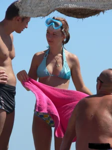 A bunch of hot babes on the beach in thong bikinis