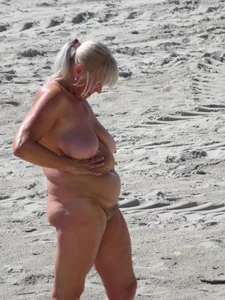 Mature blonde lady on a nude beach with big boobs
