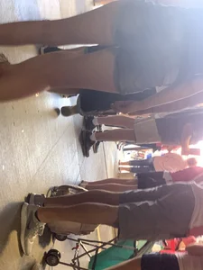 Bunch of girls in various outfits at a Cardinals baseball game