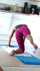 Sexy girlfriend doing yoga at home in leggings