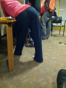 Girl in Pants Bending Over Table Creepshot