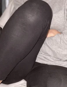 Girl in Tights Sitting With a Bent Leg Closeup Creepshot