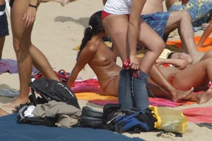Topless girls on a beach in Barcelona