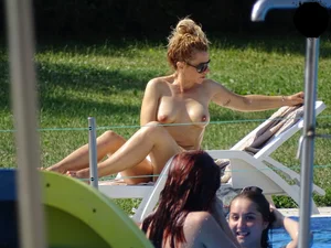 Topless lady at the pool with nice tits
