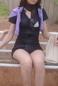 Sexy young milf in a short dress sitting on a bench, she's got hot legs